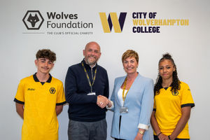 Will Clowes (Wolves Foundation) and Louise Fall mark the deal with students from the programme.