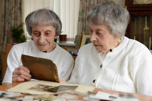 Joan (left) and Jessie looking at old photographs.