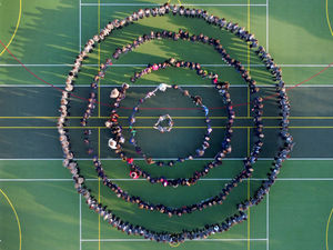 Supporting image for story: School pupils link hands to symbolise start of Children's Mental Health Week.