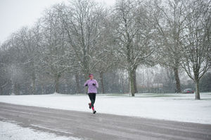 A jogger takes an early morning run in the snow at the Long Walk near Windsor Castle, Berkshire, as parts of the UK wake up to snow and a yellow weather warning. Photo: Yui Mok/PA Wire