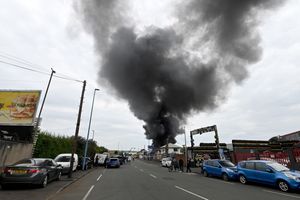 Black smoke pours into the sky from the fire at GB Tyres in West Bromwich. Photo: Tim Thursfield