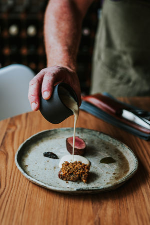 Finishing touches at Wild Shropshire, sauce poured with quiet precision onto a dish that speaks of the land