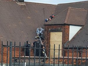 Supporting image for story: Drone images show police rooftop drama as cannabis farm found in empty Walsall school 