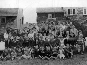 Cheerful neighbours in Walford Avenue, Bradmore, at a street party to celebrate VE day in 1945