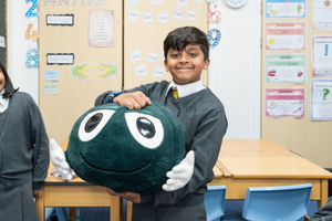 Boy with his new friend Buddy, the NSPCC's friendly mascot.