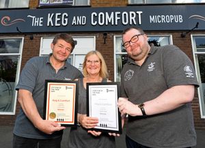 John and Louise Clive from the Keg and Comfort are presented with their awards from Mark Hewitt, Chairman of Wolverhampton CAMRA