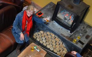 Kathryn McCluskey from Ludlow keeps warm by the fire