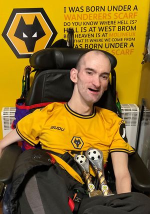Former disability wheelchair star Simon Jordan with a selection of trophies