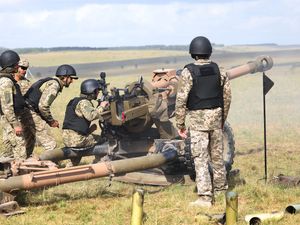 British and New Zealand soldiers train Ukrainian troops in firing a light artillery gun