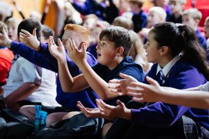 Schoolchildren watching the match