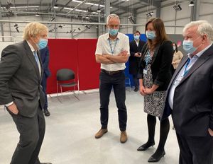 Prime Minister Boris Johnson chats to staff and volunteers during a visit to Tunstall Covid-19 Vaccination Centre