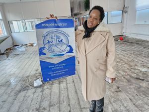 Merabelle Nahbila stands inside the remains of the charity's headquarters