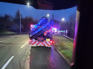 Supporting image for story: Car ends up on its roof after crashing into barrier at roundabout over M54