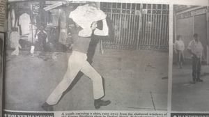 A man runs off with a shirt after looting Foster's in Dudley Street, Wolverhampton