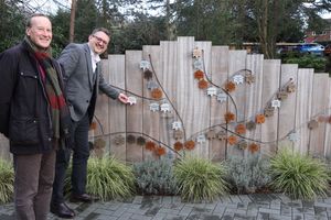 Paul Reynolds and Adam Frankling from Birchfield Educational Trust hang a leaf on the Recognition Wall at Compton Care