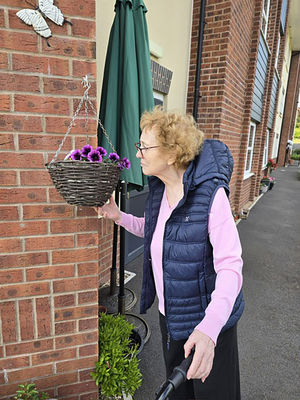Resident Anne Cole at HC-One’s Sedgley Court Care Home gardening 