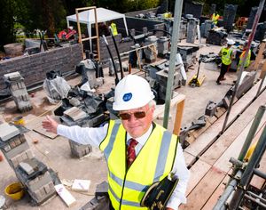 Chris Thomas Station Master stands among the ongoing construction work. 