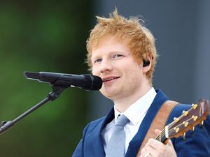 Ed Sheeran performing with a guitar