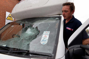 Forces Support driver Trevor Farrow looks at the damage caused to one of the West Bromwich based charities van's after vandals attacked it yesterday.