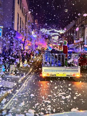 Snow falling in Builth Wells' high street as Santa's procession took place