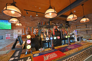 General Manager Puran Panth and co-owner Amardeep Rai show off the drinks on offer