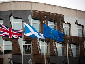 A union flag, saltire and EU flag fly side by side