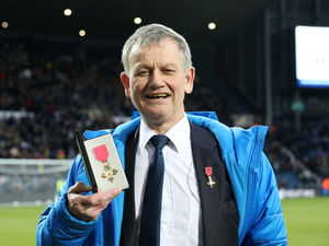 Supporting image for story: 'Blind Dave' shows West Brom fans his OBE after marathons achievement