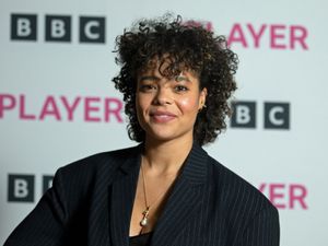 Headshot of Lydia West standing in front of a BBC iPlayer background