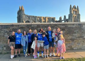 Lewis (middle) with family and friends as he arrived in Whitby