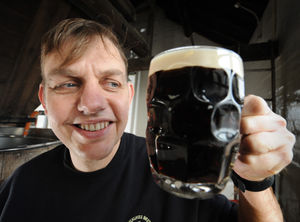 Simon Massey, raises a glass of Sarah Hughes' Dark Ruby Mild 