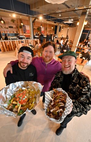 In purple is one of the Digbeth Dining Club Directors: Bobby Barnes, and with him is Vendor: Dan Lee from Hawker Dan (Asian Street Food) and Pete Hannibal  'Disco Fries'. (Photo: Steve Leath)