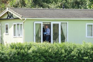 Police searching a static caravan at the scene. Image: @SnapperSK
