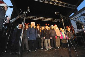 Schoolchildren from Queenswood Primary School sing carols before the Christmas lights switch on in Oakengates