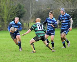 Market Drayton RFC (Green) v Shrewsbury (Blue) at Greenfields, Market Drayton. Peter Thomas runs past Ben Tokai. 