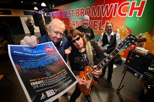 The first Henrys Blueshouse event at West Bromwich Market Hall. Band is Rich Dickinson's Driving Force with Rich Dickinson on vocals and guitar, Bass: Rich (Davie) Sleep, Drums: Ted Thundersticks. With the poster is Jim Simpson from Henrys Blues House