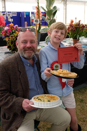  Like father like son – nine year-old Wilfred Marshall won first prize for his mini quiche in the children’s classes at the show while dad Jake, also won with his quiche. The pie making pair are from Winforton. Image by Andy Compton