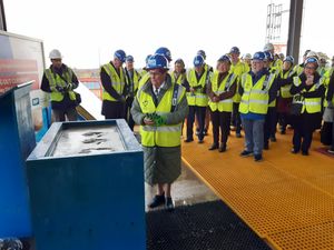 Retiring receptionist Shirley Wakeley has her hand print for posterity set in concrete. Picture: LDRS