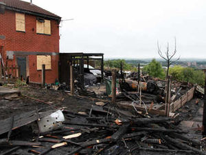 Supporting image for story: Blaze wrecks gardens and vintage vehicles