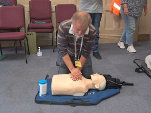 David, a repair cafe volunteer, practices CPR