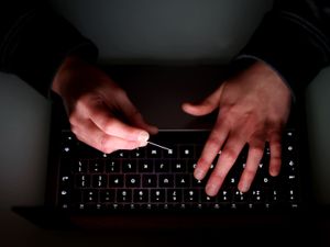 A person's hands on a keyboard