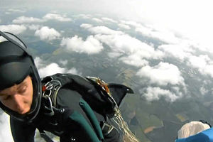 James Dobb on the side of the helicopter after the parachute deployed