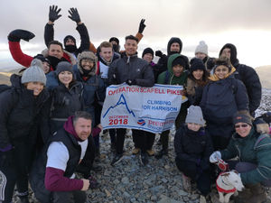 Supporting image for story: Staff scale the heights to raise money to support young Harrison