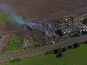 Smoke rises from the site