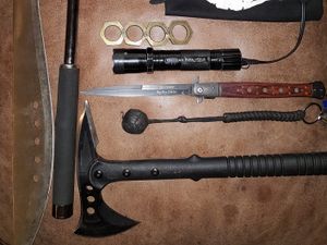 Various weapons, gloves and a mask lying on a table