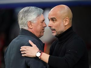 Real Madrid boss Carlo Ancelotti and Manchester City manager Pep Guardiola embrace on the touchline