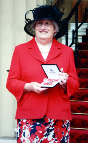 Margery with her MBE at Buckingham Palace.