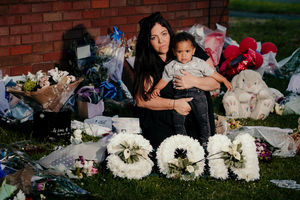 Keelan's mother Kelly Ellitts and half-brother Josiah with tributes left near to the scene