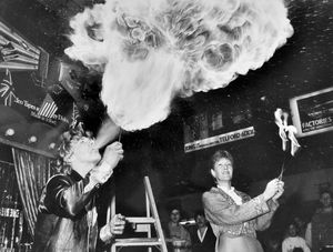 A fire eater in Telford town centre in August 1985. The caption reads: 'The Falcon Mini Circus, which has been thrilling shoppers in the Telford Town Centre all week, will be making its final appearance at the centre today. It will go out with a roar and a flash as the youngest fire-eating act in the country, 15-year-old Carl Dent from Madeley, lights up the centre with an act which can throw fire over 30ft. Carl, now a professional, comes from a circus family and first learned his skill from his father when he was only 10 years old. Watching closely is another member of the circus, Jane Kirby, Carl's mum.'