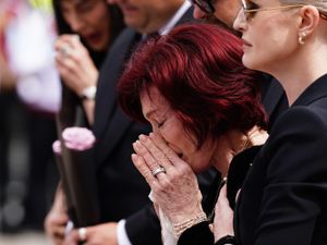 Sharon Osbourne in tears alongside her children as she reads tributes