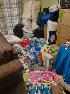 The items include nappies, baby formula, first aid supplies, torches and sleeping bags